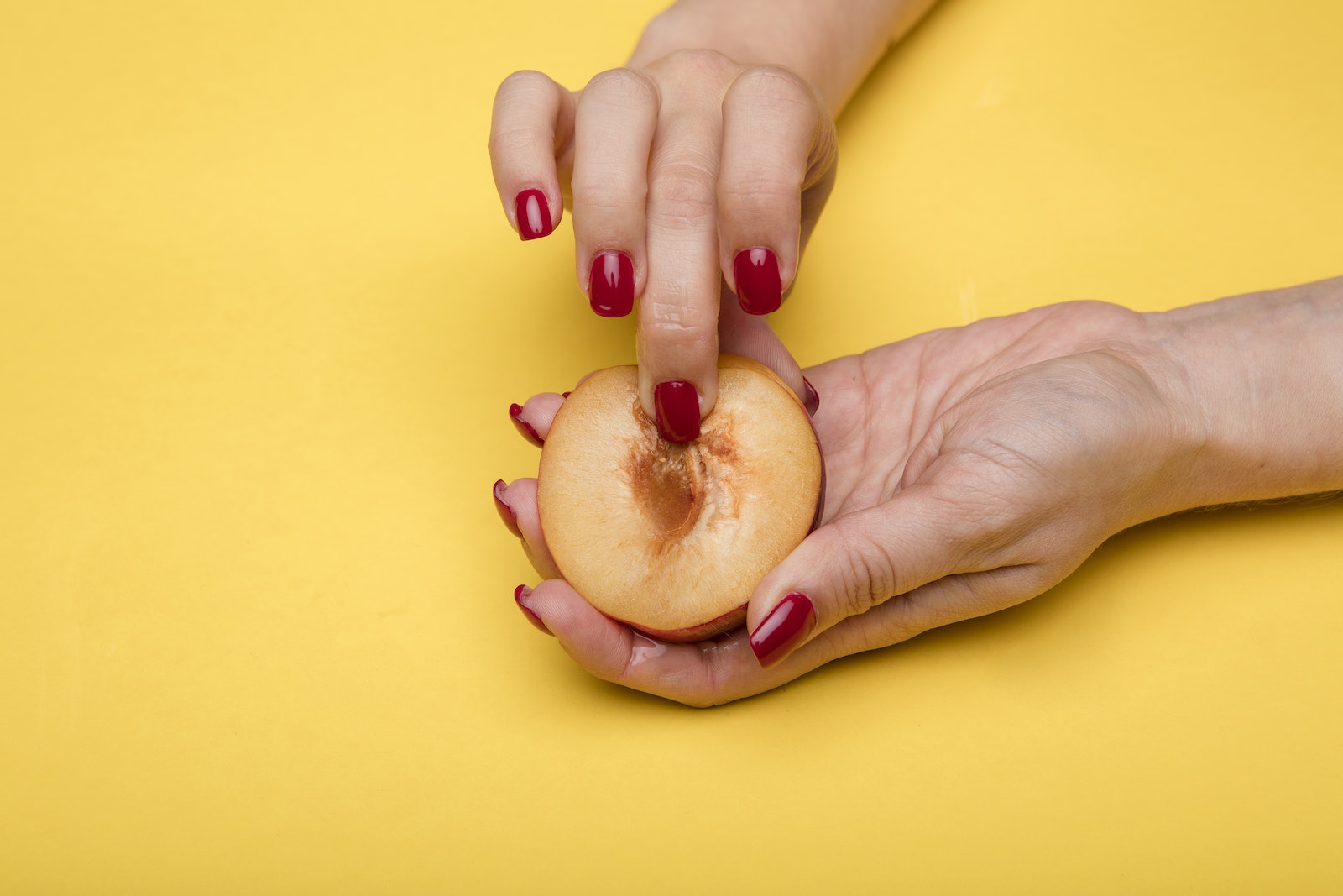 Finger on Sliced Peach