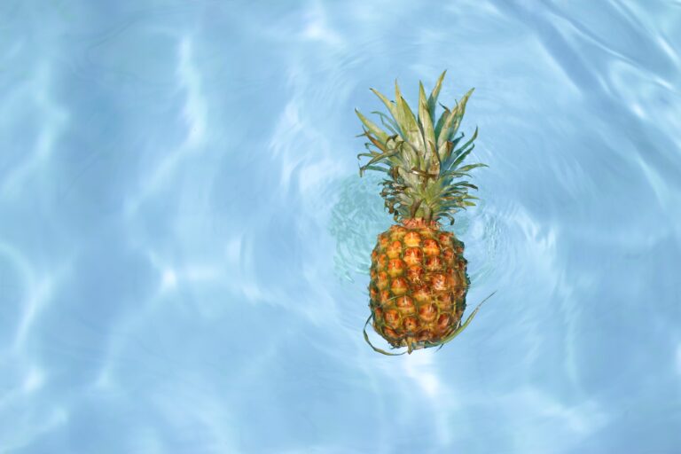pineapple fruit floating in clear water